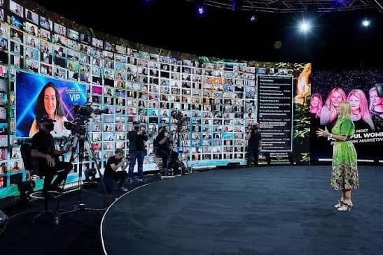 A focused audience inside the self-contained studio event