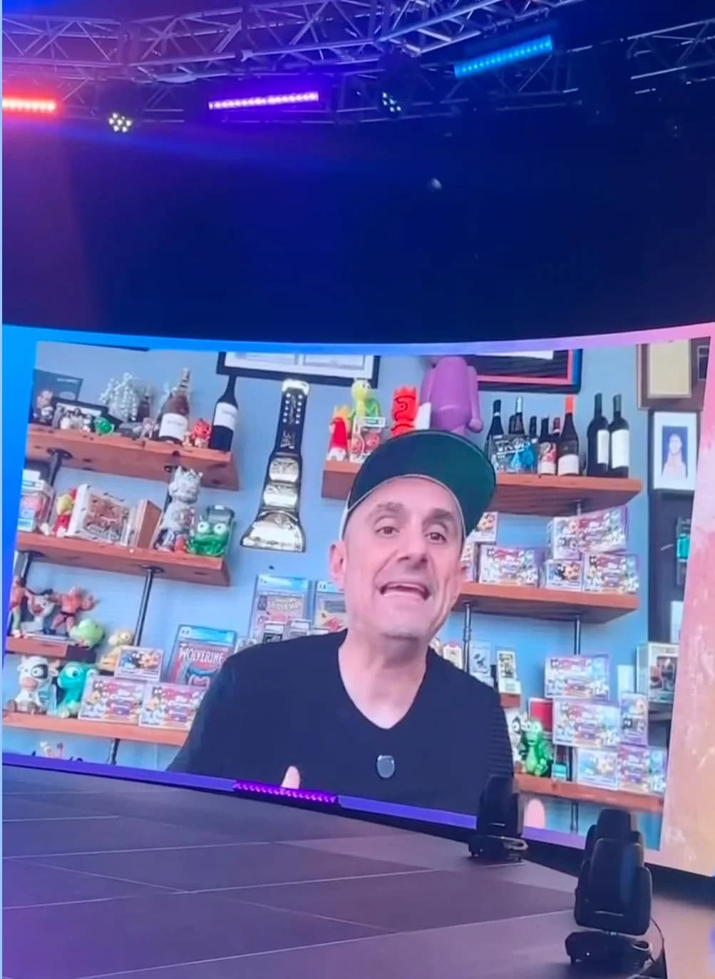 A remote guest joining live and filling the curved LED wall from a home office during a keynote.
